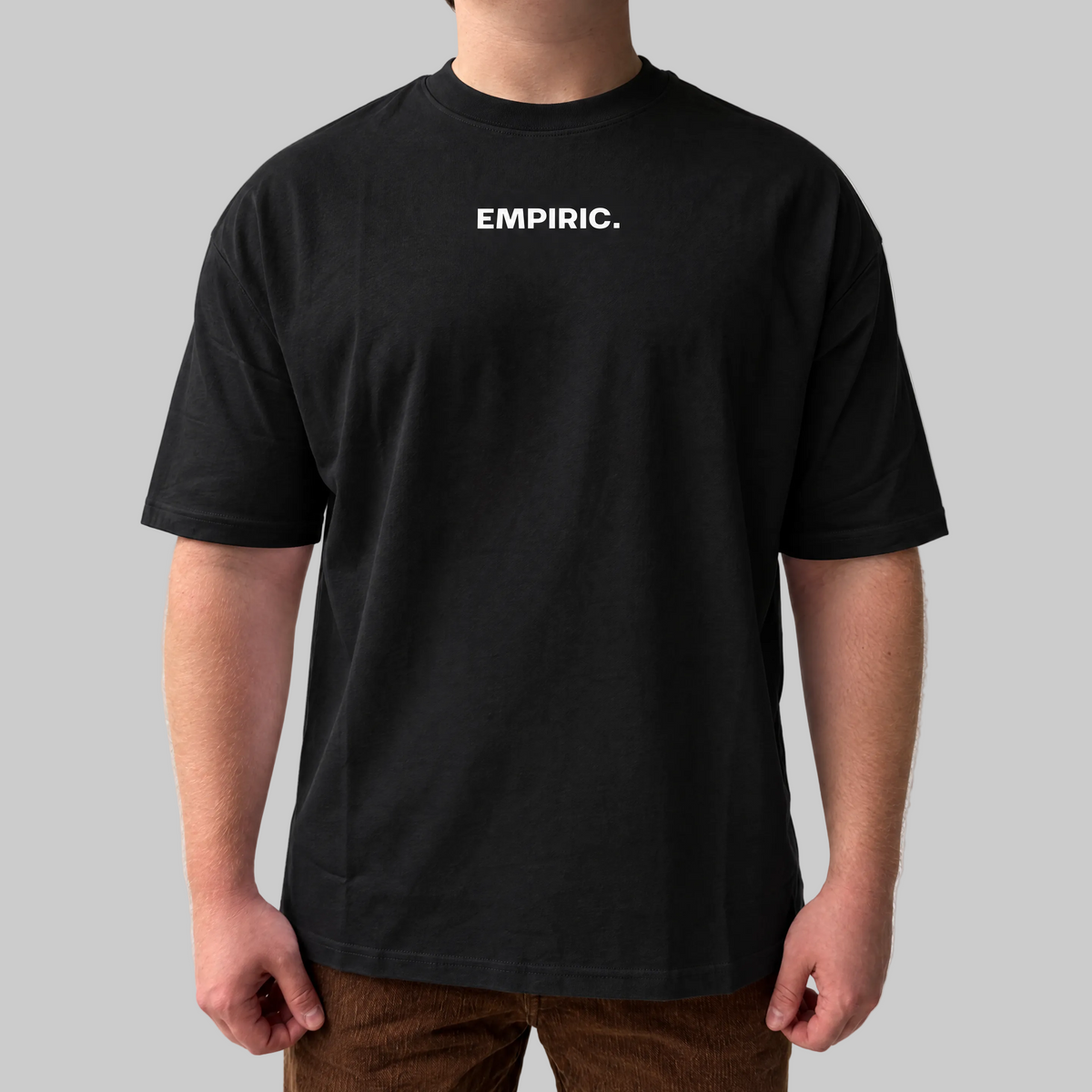 STRESS BUILDS. Tee in Black, front, on the model. Model wears XL • 5'11" • 216 lb